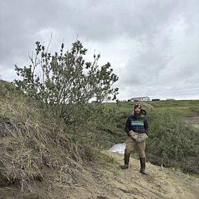 Taylor next to a large willow on the meade river